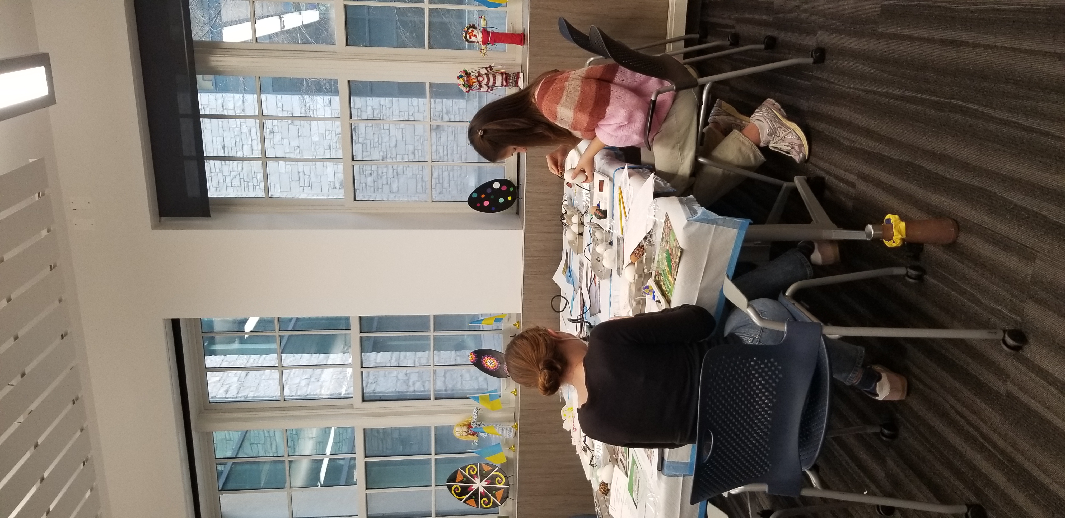 students sitting around a table working on their eggs