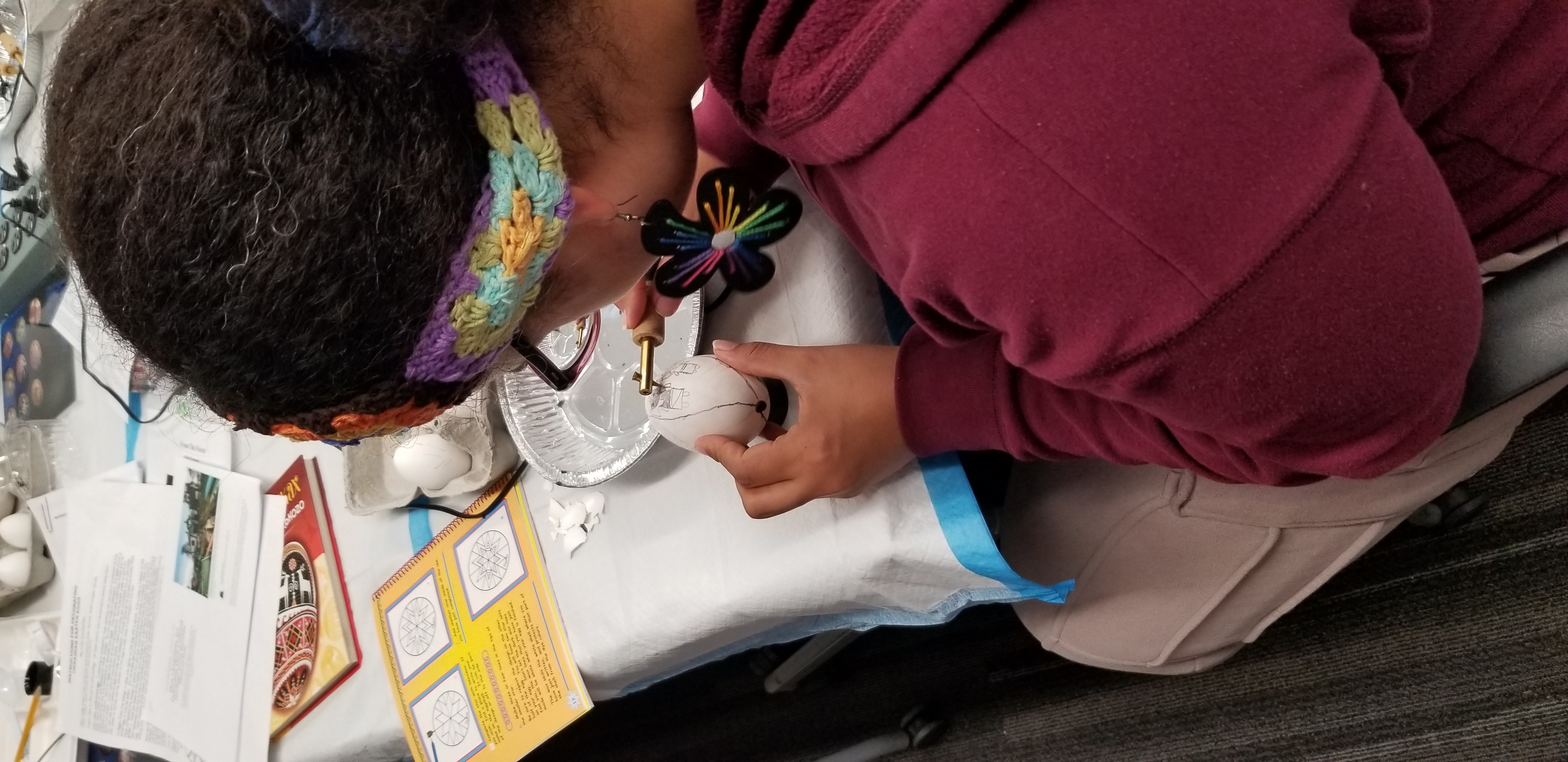 student applying wax to her egg