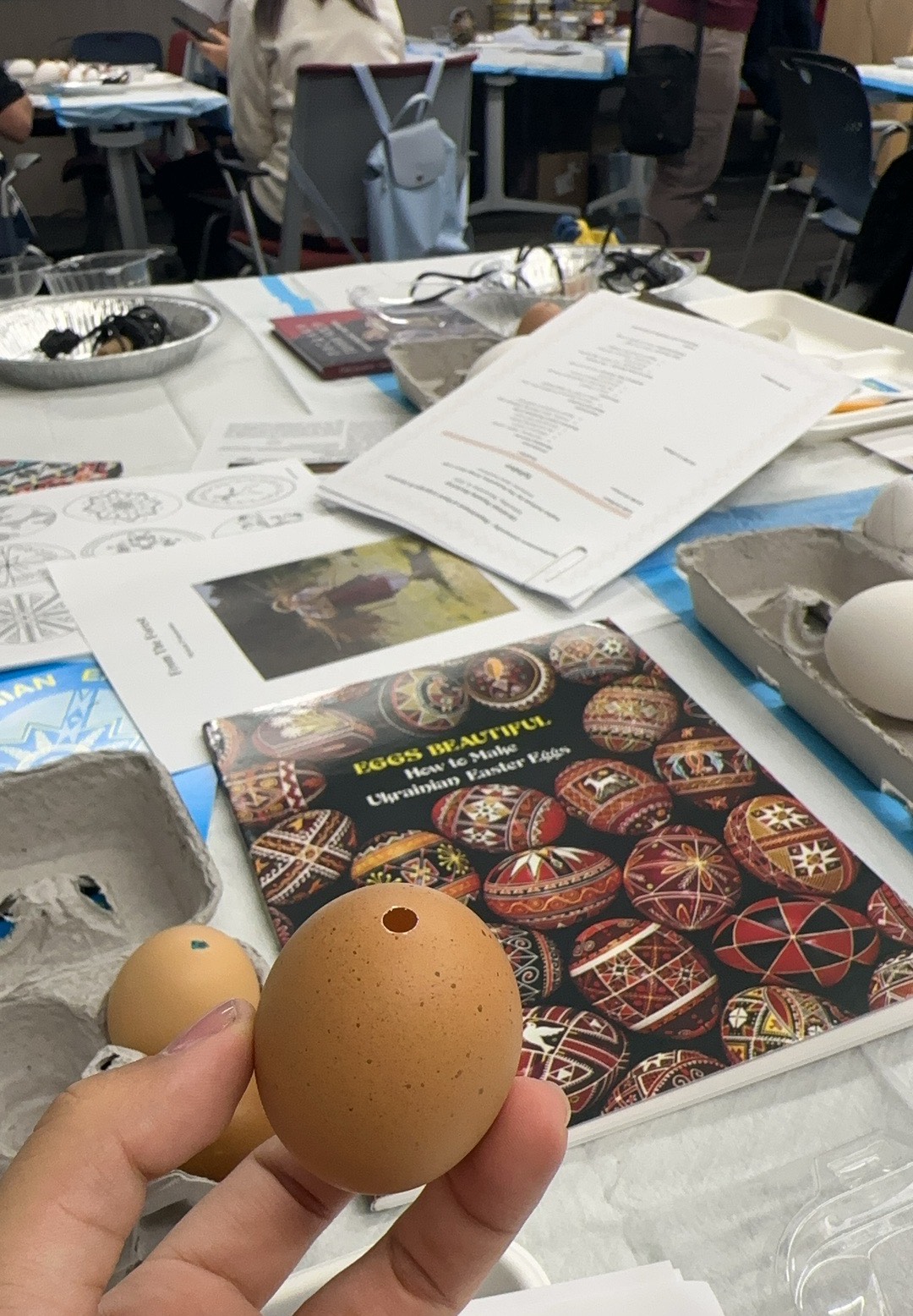A student holds a hollow chicken egg